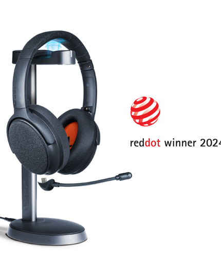 A midnight blue ONANOFF wireless ANC Bluetooth headphones with a detachable boom microphone sits on a stand, set against a clean white background. Winner of the RedDot Award 2024
