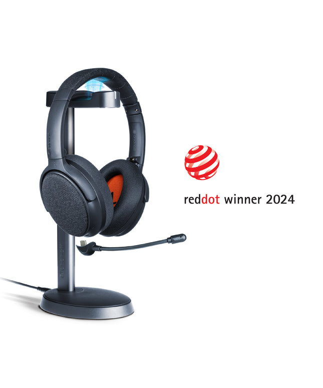 A midnight blue ONANOFF wireless ANC Bluetooth headphones with a detachable boom microphone sits on a stand, set against a clean white background. Winner of the RedDot Award 2024